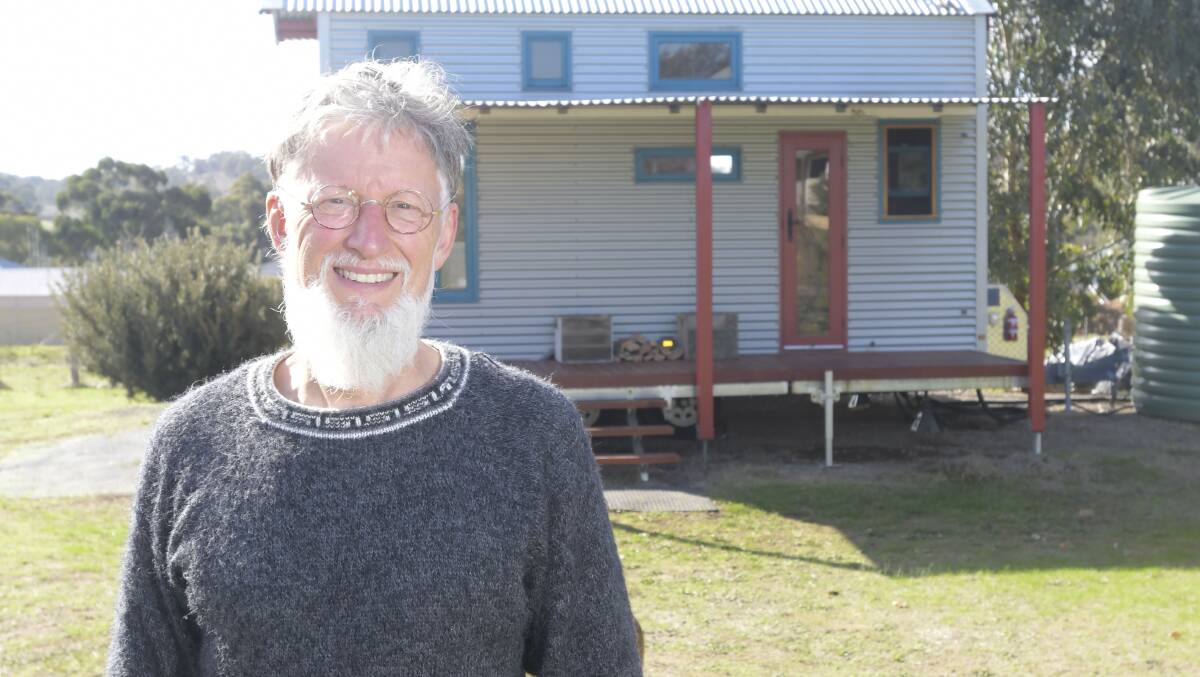 Fred Schultz at home with a tiny house on his property. Picture: NONI HYETT