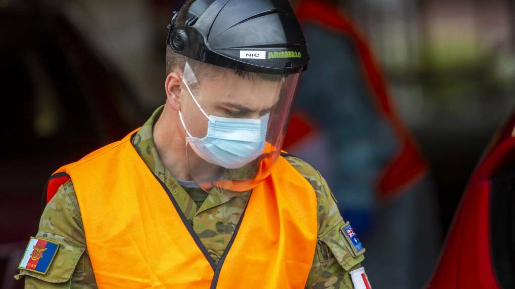 An Australian Defence Force member assists at a Bendigo testing clinic. Picture: DARREN HOWE