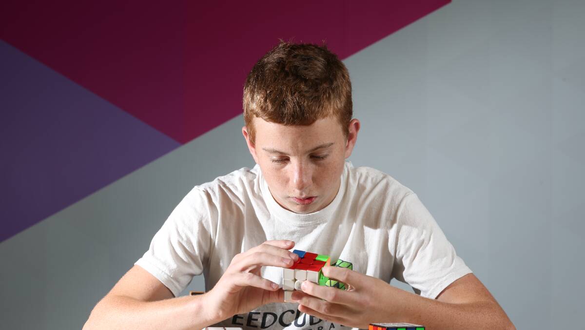 SPEED SOLVE: Brian Allen practises his Rubix Cube skills. Picture: GLENN DANIELS