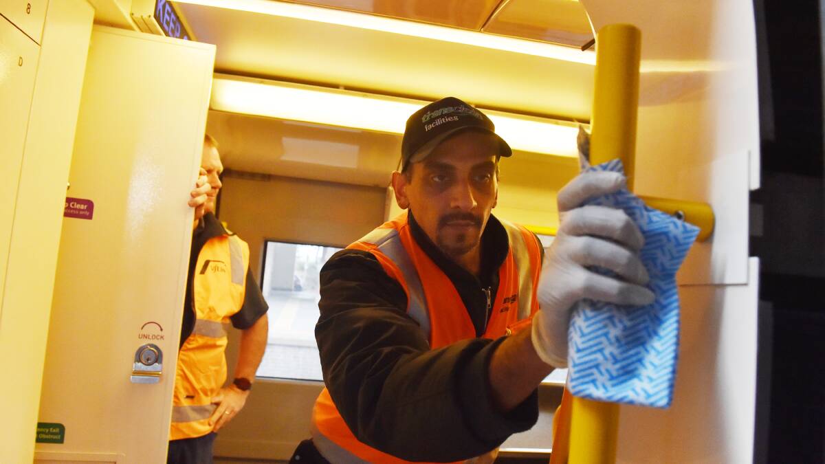 Rajender Mehla cleans a train at the Bendigo Station. Picture: DARREN HOWE