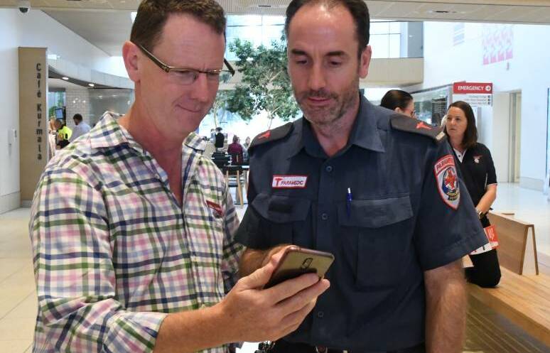 A registered responder learns about the app. Picture: CHRIS PEDLER