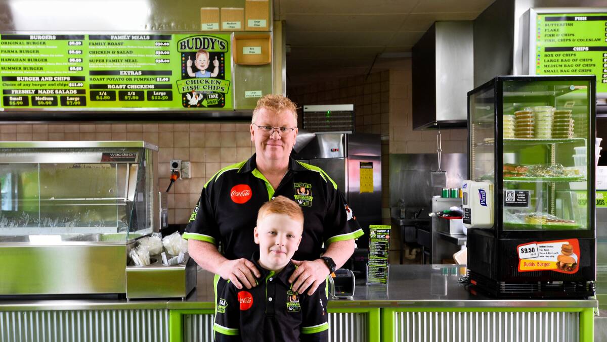 Buddy's Chicken, Fish 'n Chips and Takeway shop owner Scott Gray with his son, the shop gave away 400 free meals in one week. Picture: BRENDAN McCARTHY
