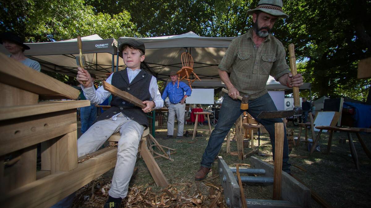 Tom Rundell, 9, flytieing (for fly fishing) with his chairmaker dad Glenn Rundell (right).