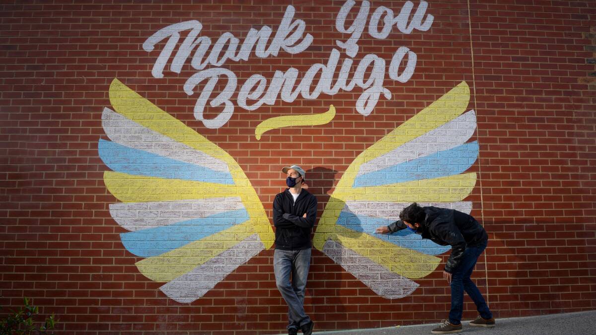 Artists Wes Franklin and Reece Hendy complete the mural. Picture: DARREN HOWE