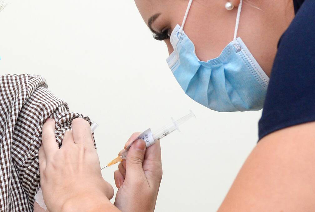 Tiana Desmond delivers a vaccine dose. Picture: DARREN HOWE