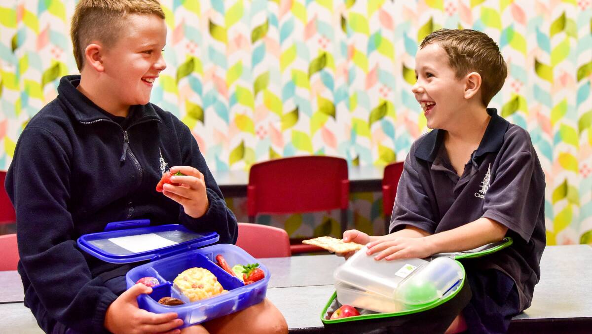 Kyah Weeks and Jarod Dole from Camp Hill Primary with their nude food lunch boxes. Picture: BRENDAN McCARTHY