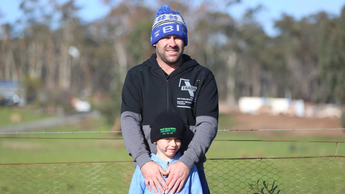 Neighbour Justin Finch with son Kolby. Picture: GLENN DANIELS