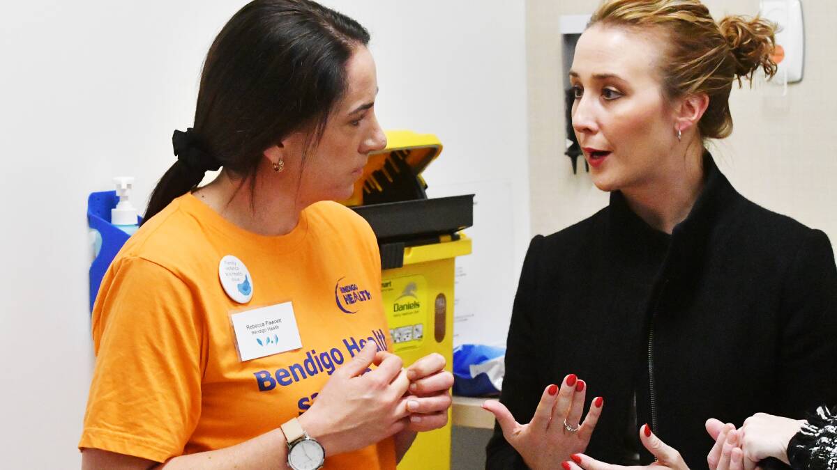 Bendigo Health nurse Rebecca Fawcett speaks with Minister for the Prevention of Family Violence Gabrielle Williams. Picture: DARREN HOWE