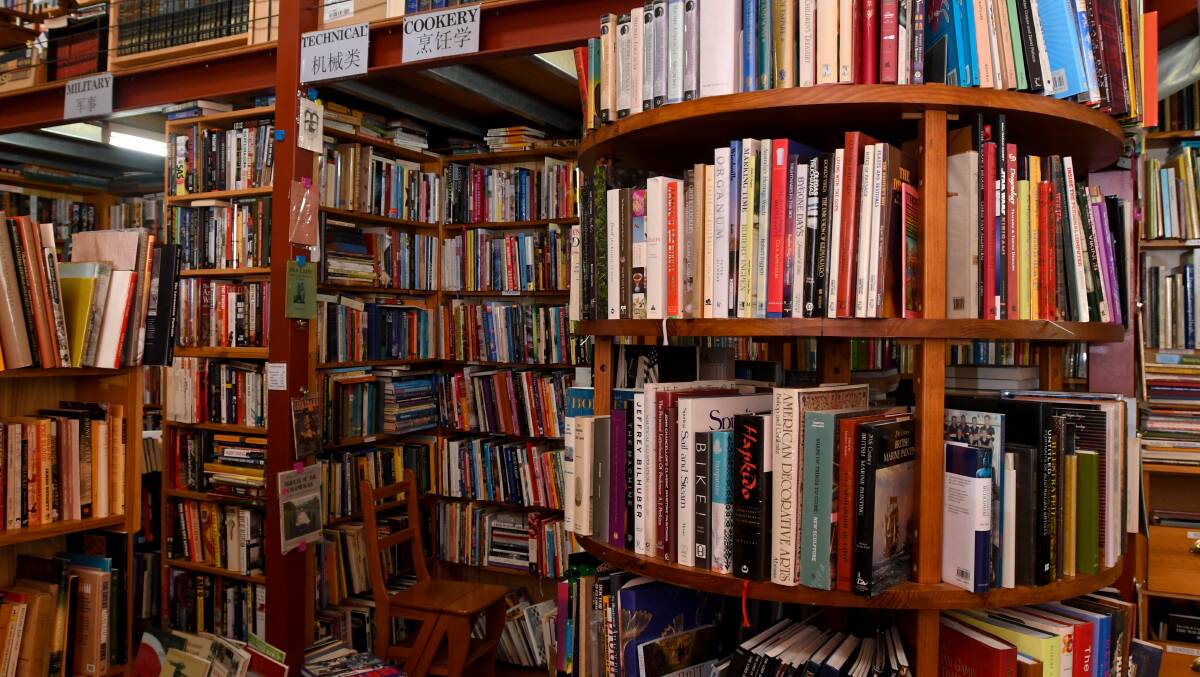 READING UP: Bookstore owner Garry Murray says tastes have changed in 35 years, but good books still sell. Picture: NONI HYETT