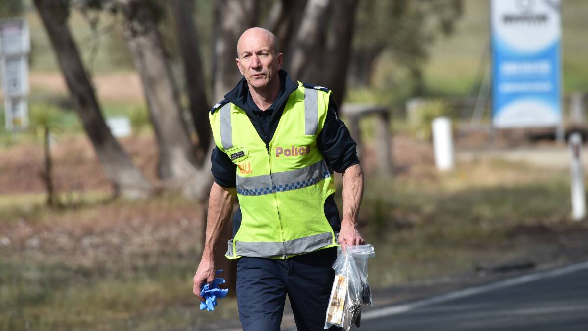 A police officer at the scene of the fatal crash in Marong. Picture: DARREN HOWE