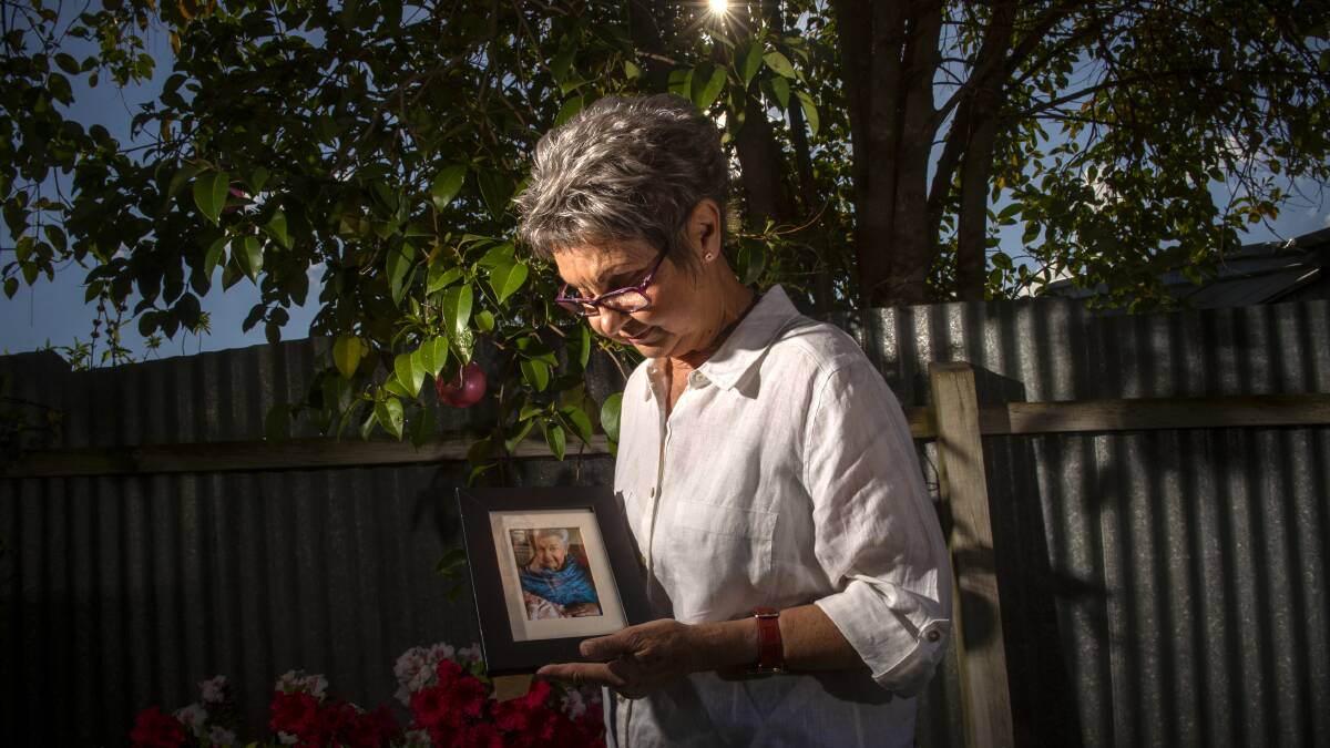 SAD TIME: Jan Claridge with a photo of her mother, whose funeral took place without many family and friends due to COVID-19 restrictions. Picture: DARREN HOWE