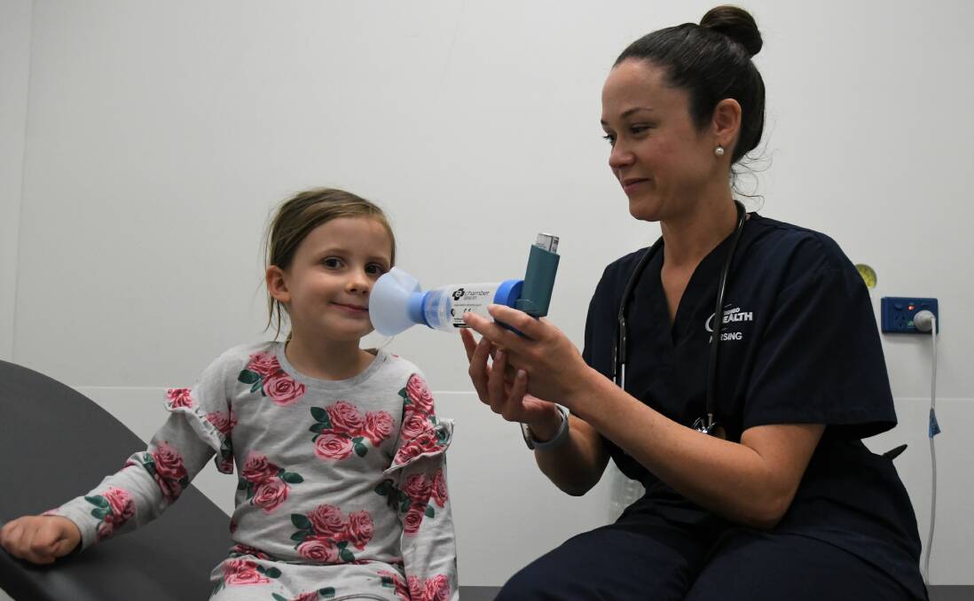 Five-year-old Piper has a look at a spacer from the Thunderstorm Emergency Kit with Emergency Department nurse Jaclyn Tyndall. Picture: ELSPETH KERNEBONE.