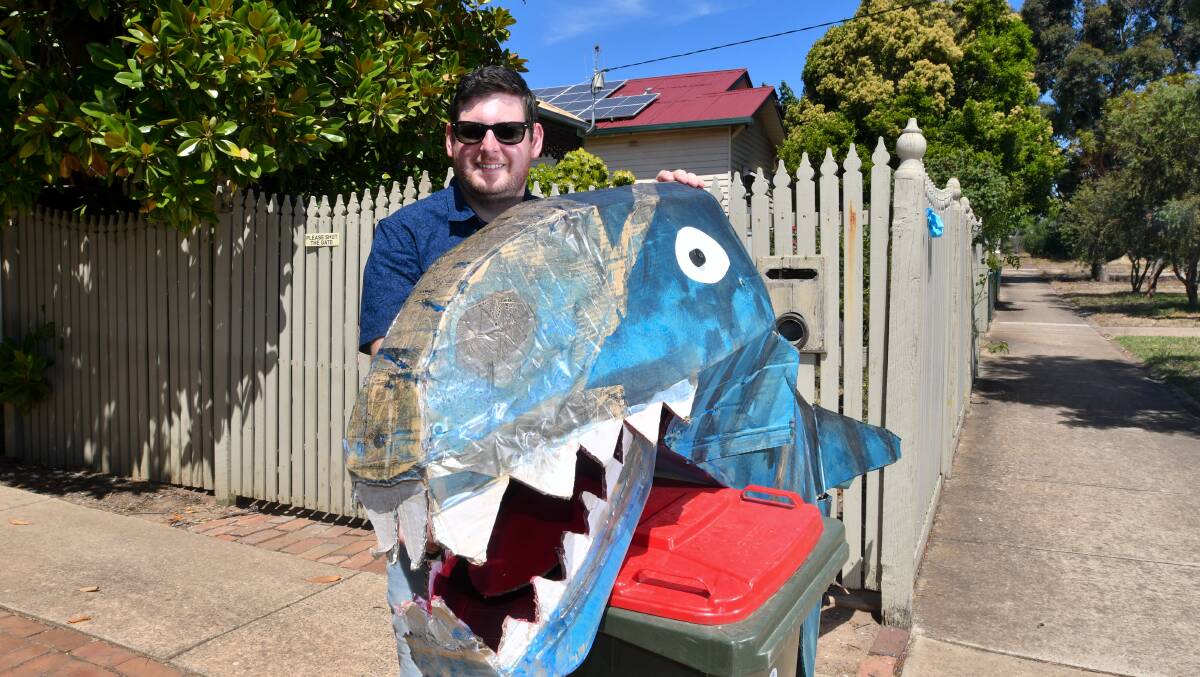 BIG NIGHT: Brad McDonald with a new bin isolation outing creation, Chomy the dinosar. Picture: NONI HYETT