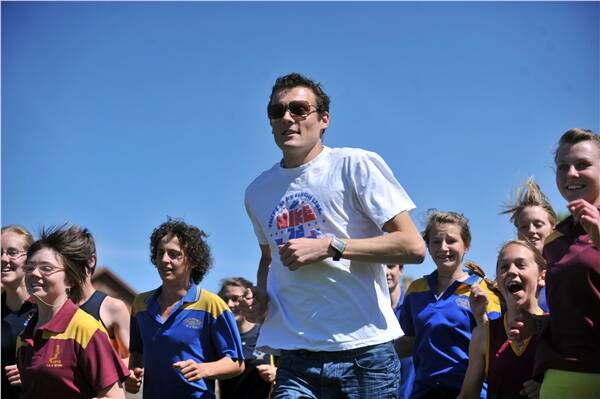 KEEP ON RUNNING: Distance running star Craig Mottram is surrounded by keen students at yesterday's clinic in Bendigo. Picture: BILL CONROY