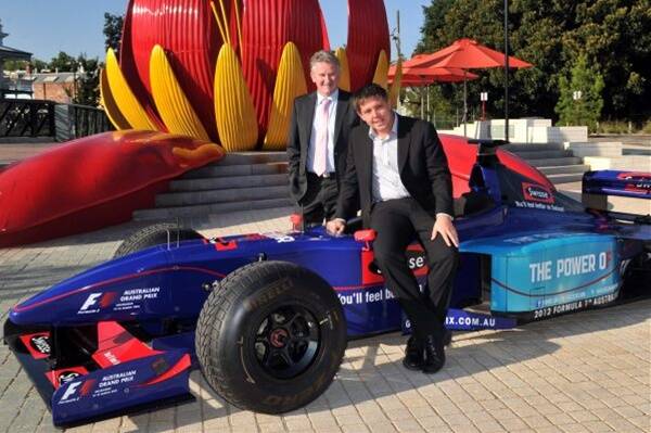 OFF and Racing: Craig Fletcher and councillor James  Reade with a formula one  car at Dai Gum San. Picture: Brendan McCarthy