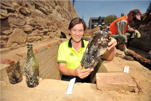RARE FIND: Archaeologist with Dig International Sarah Peisley displays a 19th century rum bottle.