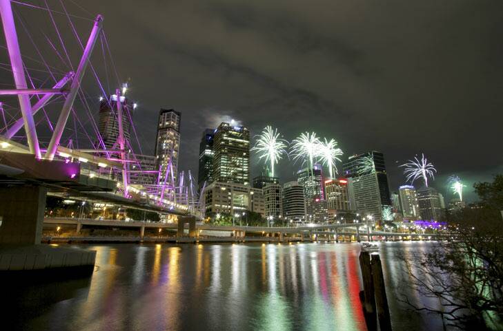 The Brisbane city skyline lights up during  Riverfire, as seen from the South Brisbane end of the Kurilpa Bridge.
