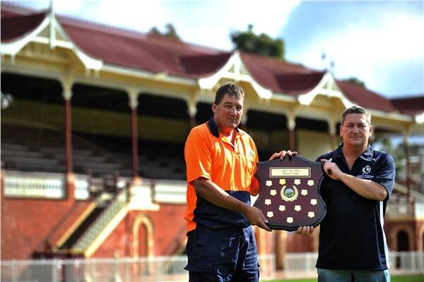 TRIBUTE: Heathcote's Wayne Bell and Mount Pleasant's Alan Kennedy hold the Cliff and Peter White Memorial Shield.