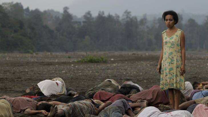 Desire for justice ... Beatriz (Irim Tolentino) searches for her husband, Tomas, among the men killed in the village of Kraras in <i>A Guerra da Beatriz</i>.
