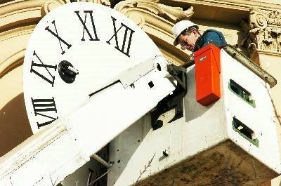 TIMELY: Steve Young prepares to place the first of the clock faces. Picture: BRENDAN McCARTHY