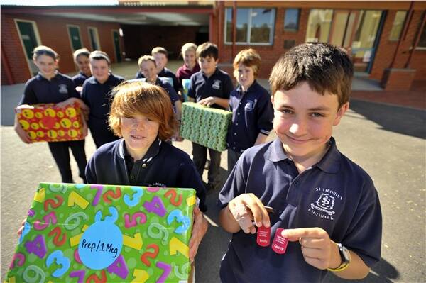 EMPATHY: St Liborius students Jacob Dullard and Dylan Gaffee, front, were off to Middle Kinglake Primary while, back, Hallee Murphy, Liam Clarke, Chloe Allen, Kaylee Finch, Katrina Mettoglu, Jordan Balnaves, Sam Carter and Darcy Conder helped to prepare the gifts.