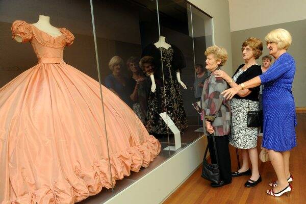 IMPRESSED: Julie Ellerton and Margaret Williams from Bendigo, along with Julie’s sister from Queensland, Wendy McMullin, admire Grace Kelly’s centenial ballgown. Picture: JULIE HOUGH