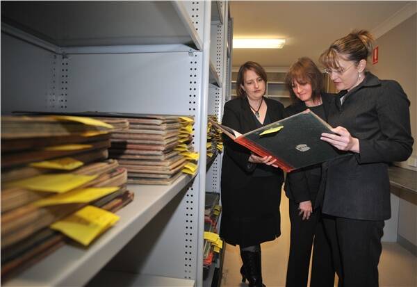 ARCHIVE: Public Records Office director Justine Heazlewood, Carolyn Macvean and Jacinta Allan examine early rate books.