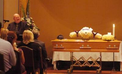 MISSED: A picture of Anthony Gobel sits atop his coffin at his funeral.