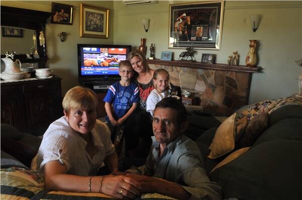 Brad Rawiller’s parents Elaine and Keith at home in Epsom yesterday with Brad’s sister-in-law Sarah and her children Campbell and Caitlin (nursing Oscar the dog). Picture: BRENDAN McCARTHY