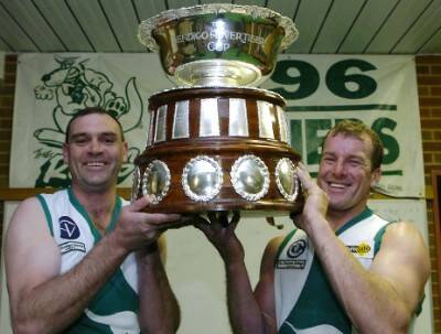 GLORY DAYS: Brett Gloury and Noel Shelton relive the 1996 premiership win by lifting The Advertiser Cup.