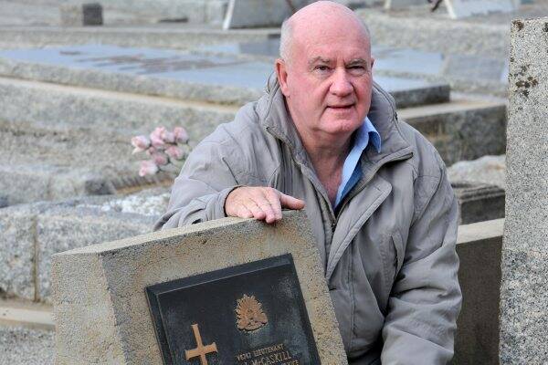 RESTING PLACE: Grandson Paul McCaskill at Bob McCaskill’s grave at the Bendigo Cemetery. Picture: PETER WEAVING