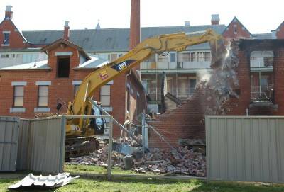 AFTERMATH: A wall of the gutted laundries at St Aidan's Orphanage is demolished.
