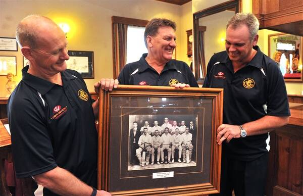 GOING PLACES: Queen's Arms Hotel owner Budge Russell, Bendigo coach Max Taylor and club president Tony Fitzpatrick with a Bendigo Cricket Club team photo from the early 1930s.