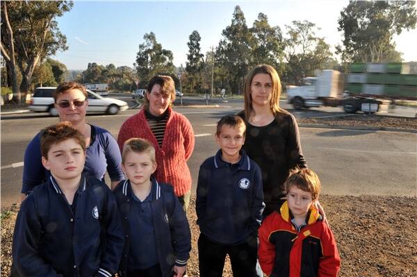 FEARS: Residents Kim Mayer and her sons Nickolas and David, Joanne Harris, Sandra Hillier and sons Riley and Heath urge a review of the Strathfieldsaye Road and Tannery Lane intersection.