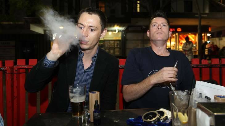 Recharging: Leon Alegria and Damian Duncan enjoy their electronic cigarettes at their local pub. Photo: Sahlan Hayes