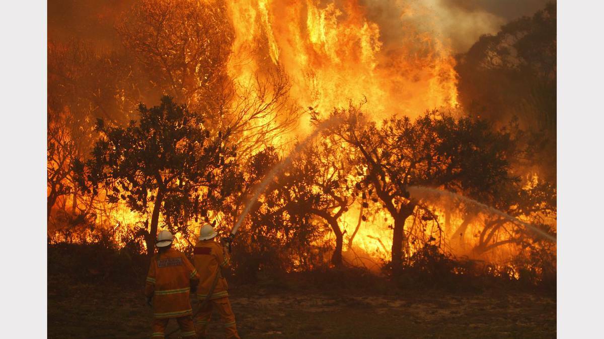 Scenes from bushfires at Fingal Bay and Lemon Tree Passage, Port Stephens on Sunday. Photos: JONATHAN CARROLL, PHIL HEARNE