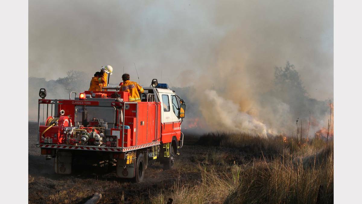Scenes from bushfires at Fingal Bay and Lemon Tree Passage, Port Stephens on Sunday. Photos: JONATHAN CARROLL, PHIL HEARNE