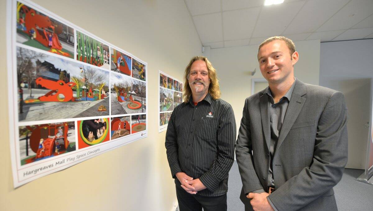Council staff Gary Lantzsch and Lincoln Fitzgerald with the Hargreaves Mall playground designs they helped create. Picture: Blair Thomson