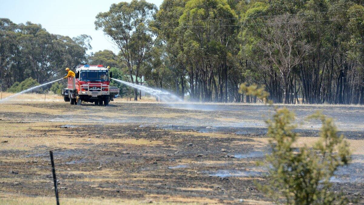 Damping down: CFA crews mop up after the fire in Schumakers Lane, Maiden Gully. Pictures: JIM ALDERSEY