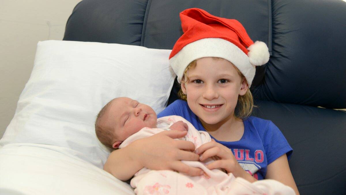 PROUD: Izzy Lisa McAllister, 7, nurses her new sister Madelyn Ethne Bruce. Picture: JIM ALDERSEY