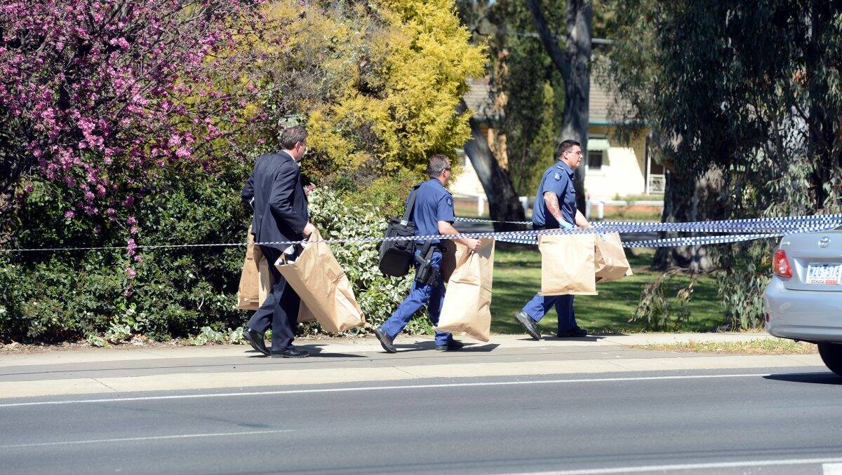 INQUIRIES: Police remove evidence from the house. Picture: JIM ALDERSEY