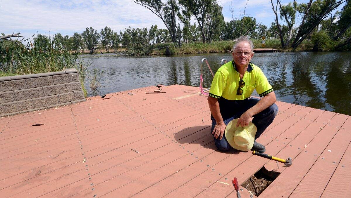 OUTRAGE: Council contractor Mark Simmonds with the vandalised dock. Picture: Jim Aldersey