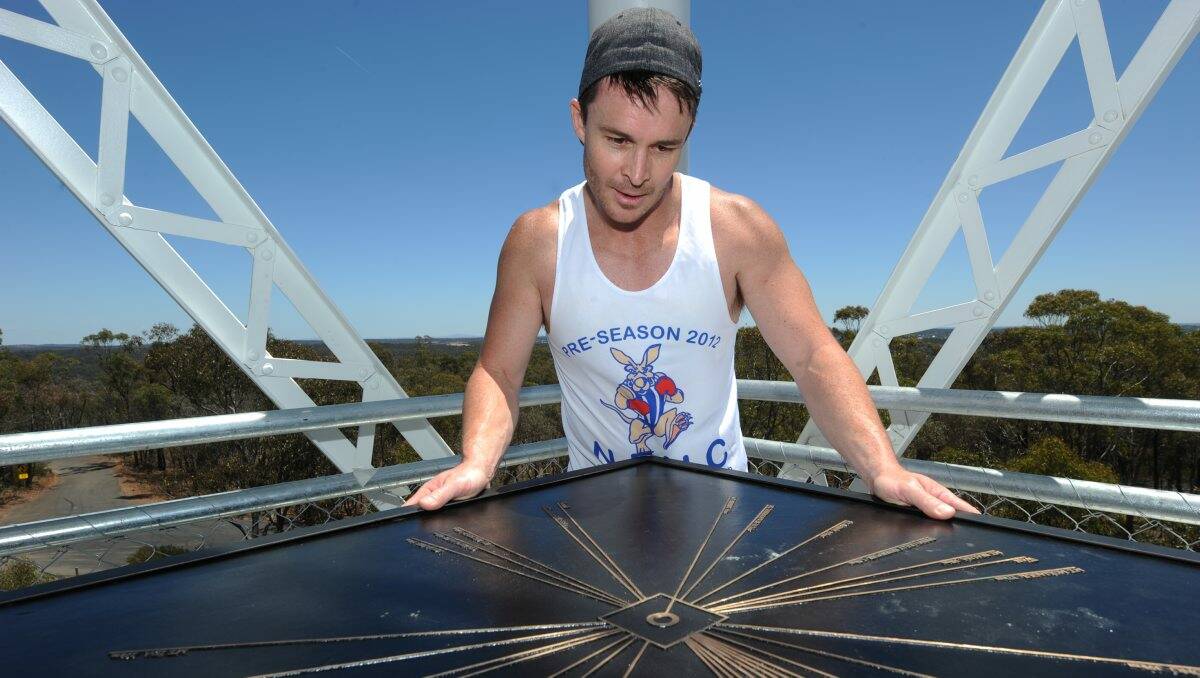 PUZZLED: Shane Harvey from Strathdale was yesterday confused by the direction marker at One Tree Hill lookout. Picture: Blair Thomson