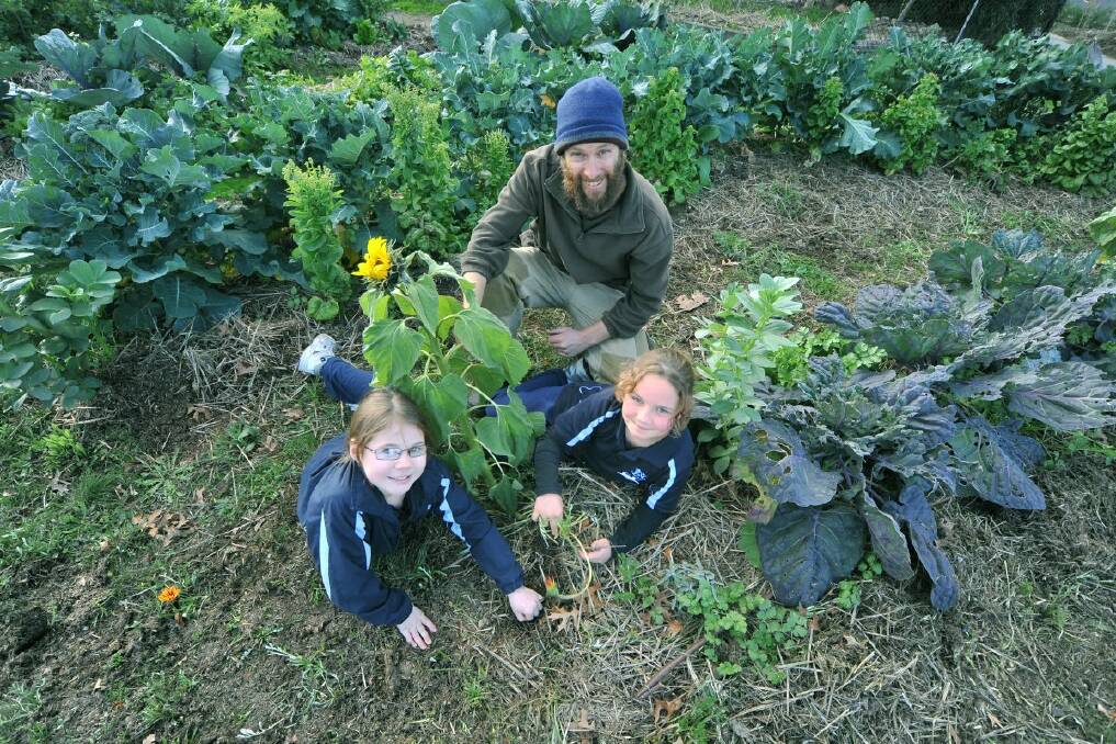 Brooke McNaughton and Lena Johnston with garden teacher Brian Hosking. Picture: Brian Semmens