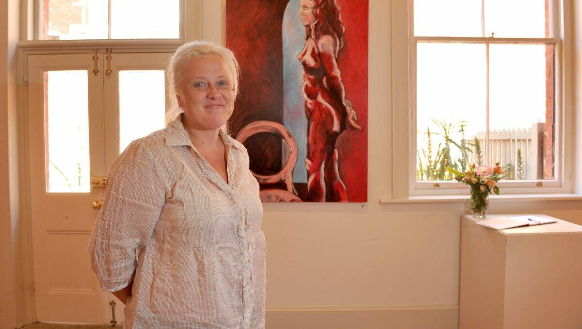 PERSONAL: Artist Amber Sansom with work from her exhibition Going Solo. Picture: JODIE DONNELLAN