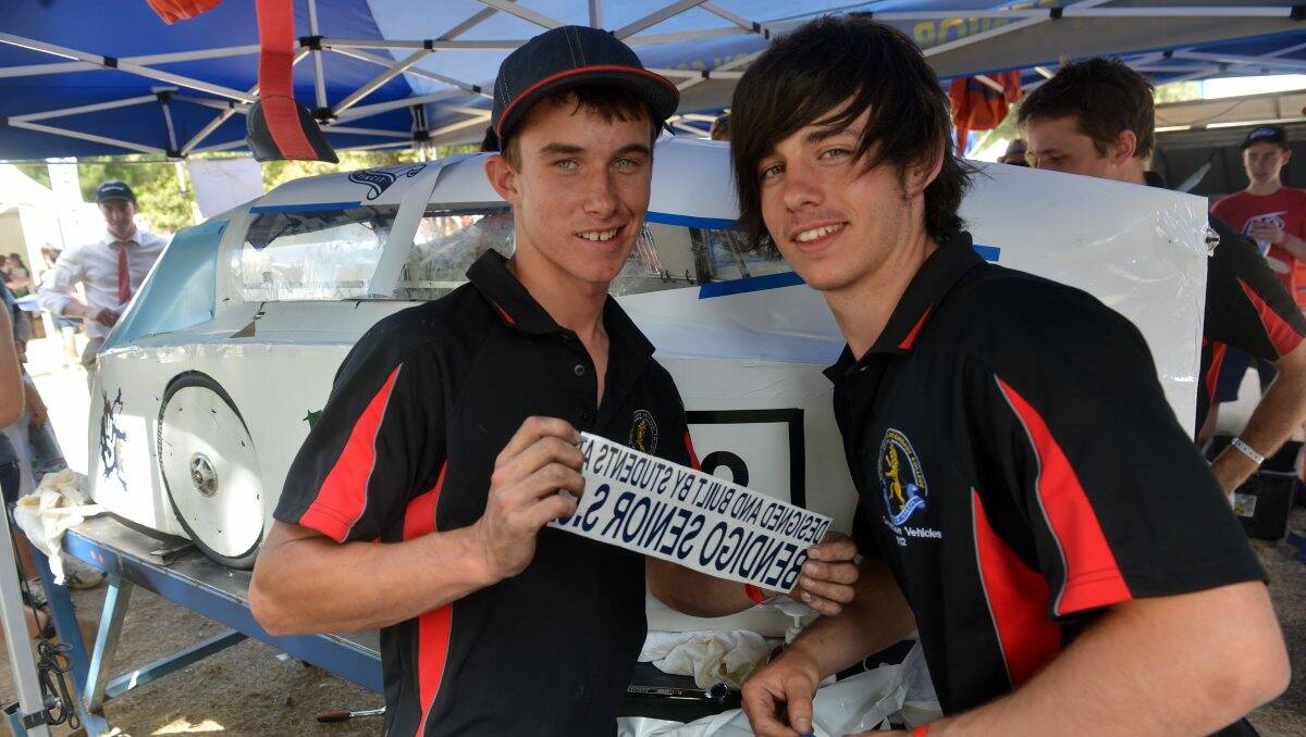 MOTIVATED: Bendigo Senior Secondary College students Tyler Hamilton and Jordan Dole label their ‘DIY’ vehicle with the all important branding as they race to the finish.  Picture: BRENDAN McCARTHY