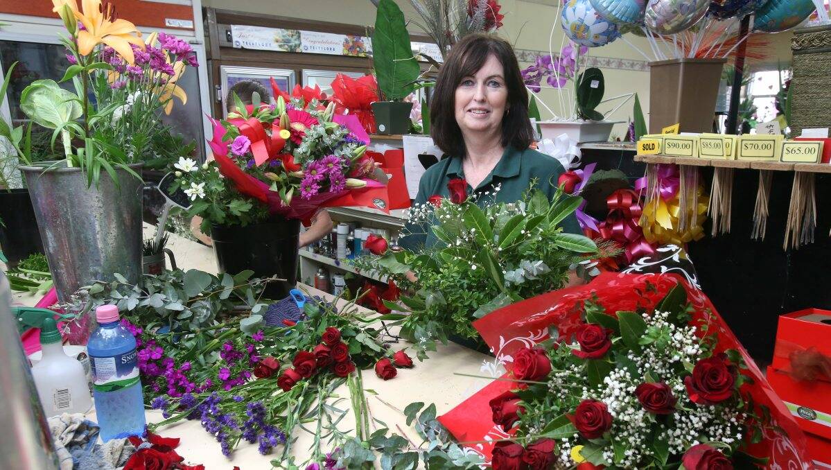 Big day: A very busy Carol Tuohey at The Petal Factory. Picture: Peter Weaving