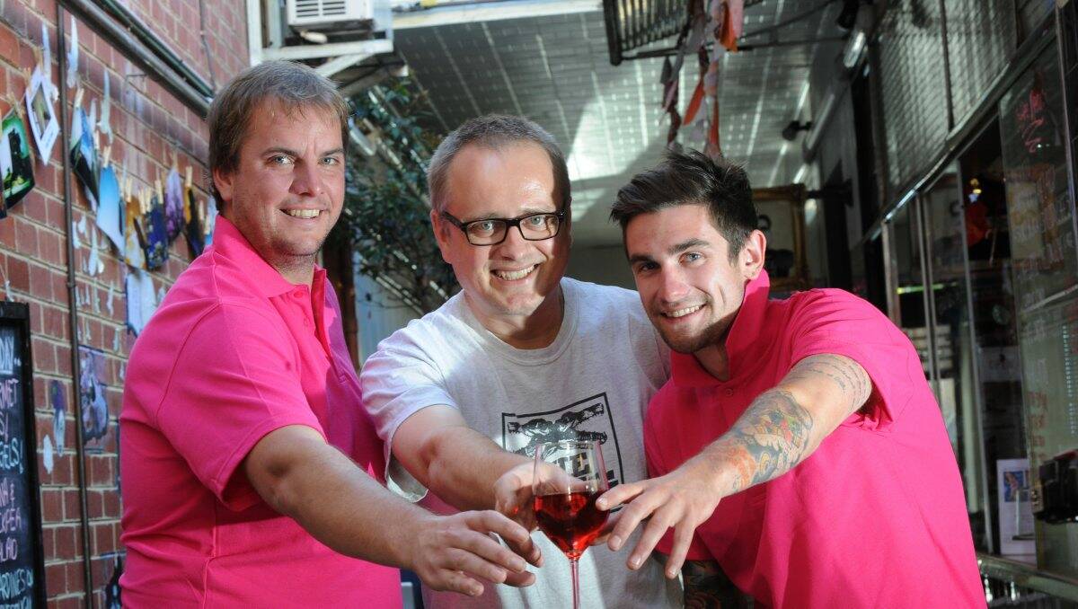 AMBASSADORS: Rose Revolution’s Ash Raeburn and Sam Bowman with cafe owner Oliver Budack (centre). Picture: PETER WEAVING