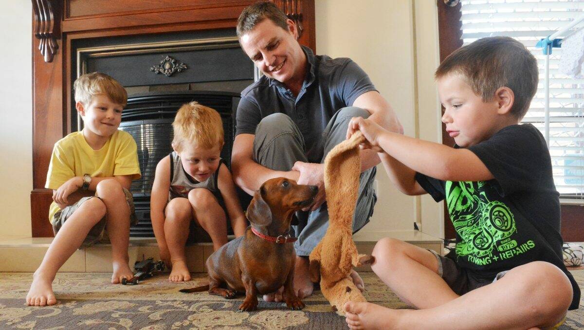 PART OF THE FAMILY: Delilah entertains Oliver, 8, Wilbur, 3, dad Jarrod and Angus, 5, Martin. Picture: BRENDAN McCARTHY