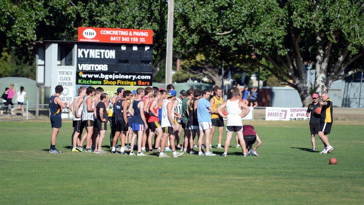 Kyneton coach Brian Walsh leads the young squad at training.